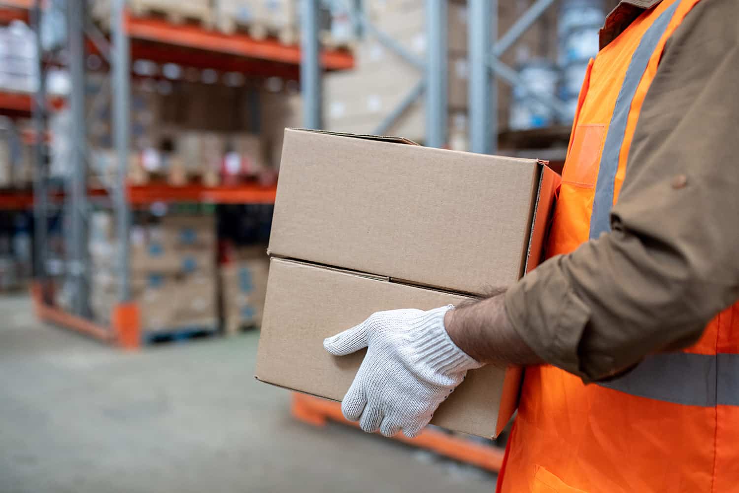 stock-photo-warehouse-engineer-in-workwear-carrying-boxes-with-goods-1998474311